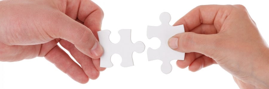 hands joining puzzle pieces together