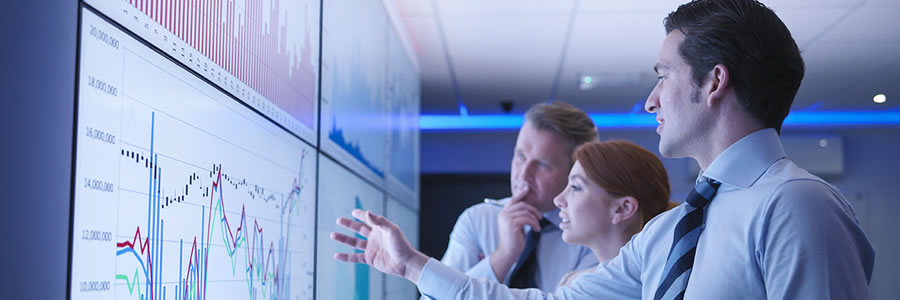 Team viewing graphics on large screen