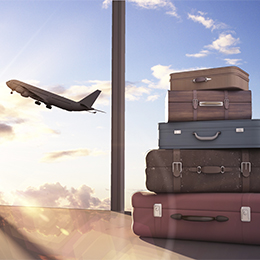 Vintage luggage with inflight aircraft behind