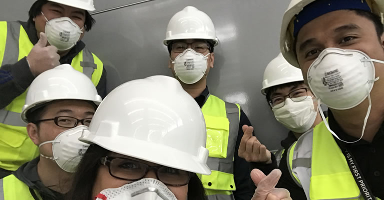 Workers in hardhats and masks